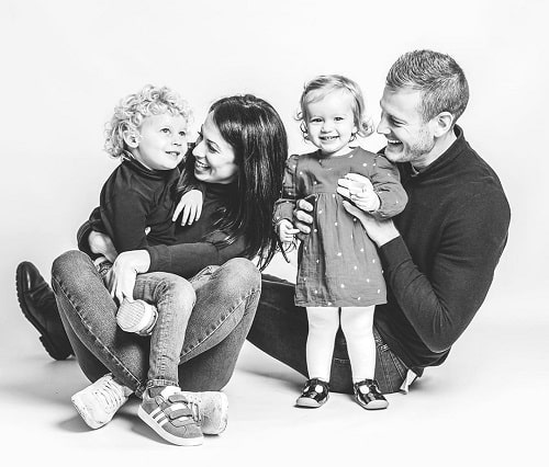 A picture of Tom Hopper with his wife and kids.